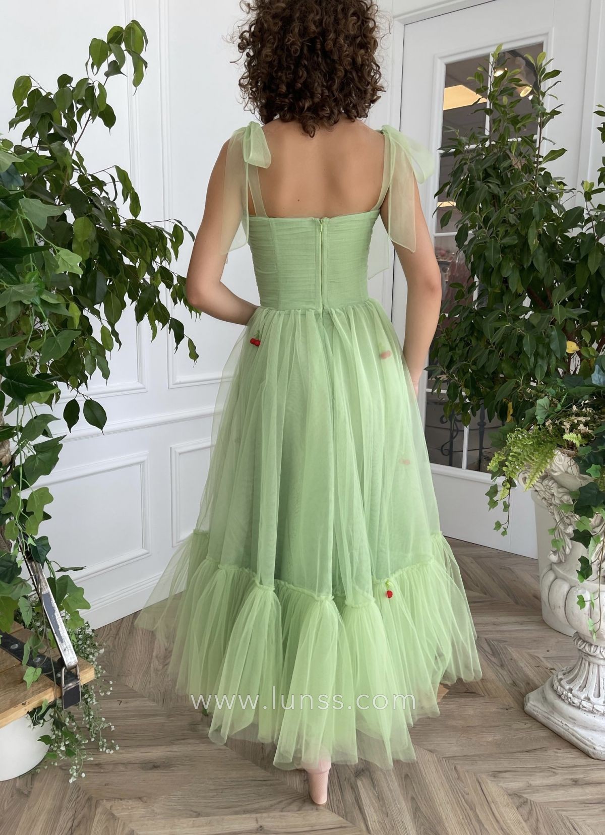 green tulle tea length dress with cherry decorations
