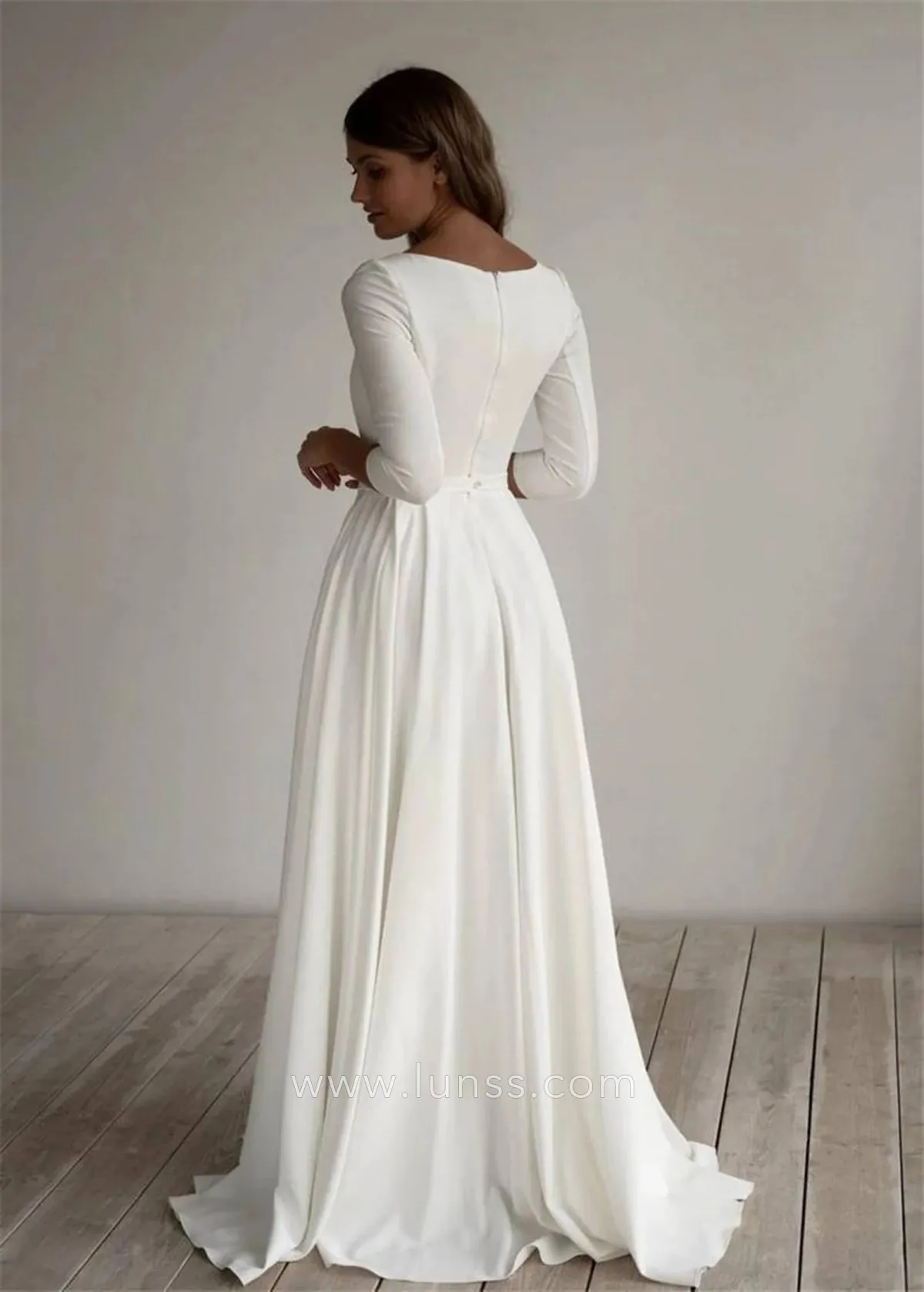 minimalist ivory satin closed back bridal dress with a sweep train