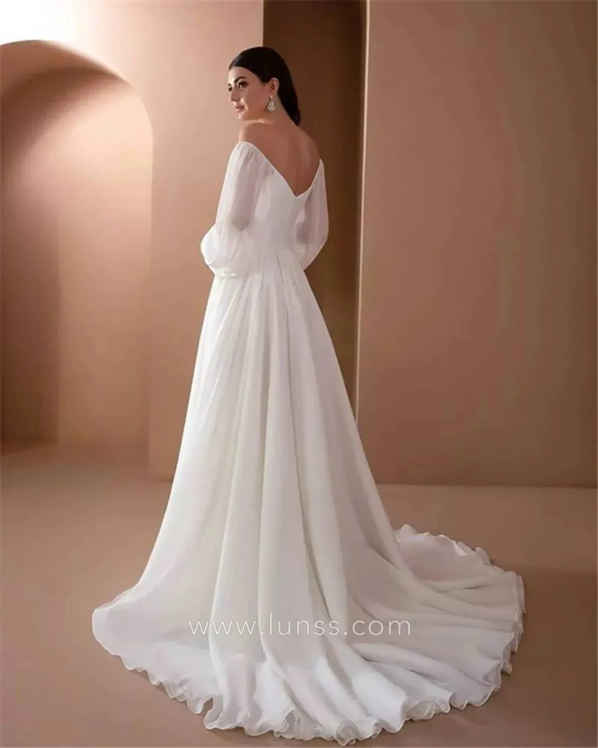 simple long sleeve v back outdoor bridal gown with a court train