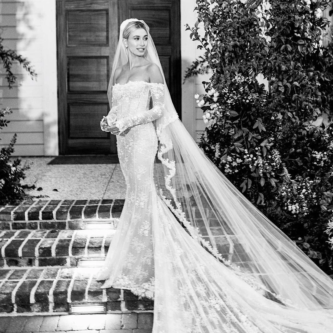 Hailey Bieber off shoulder lace mermaid wedding dress with chapel train