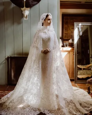 Lily Collins high neck lace bridal dress with hooded cape