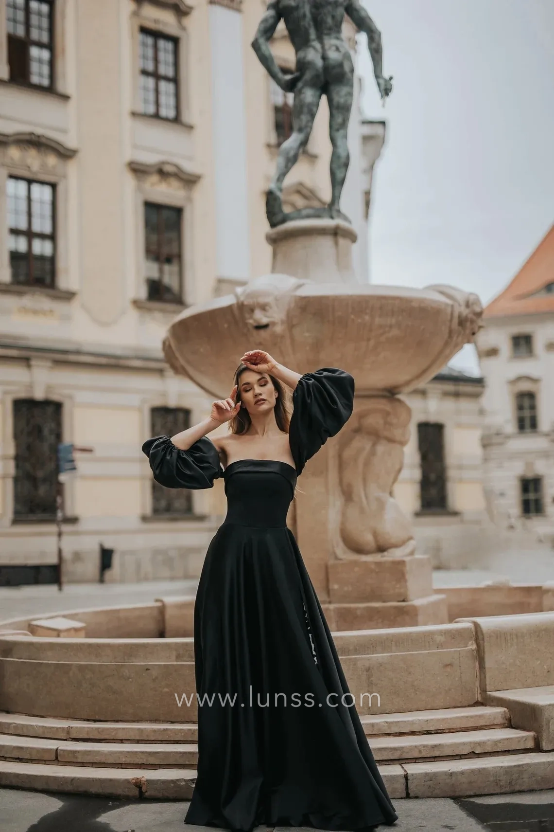 black satin strapless A line evening gown with lantern sleeves