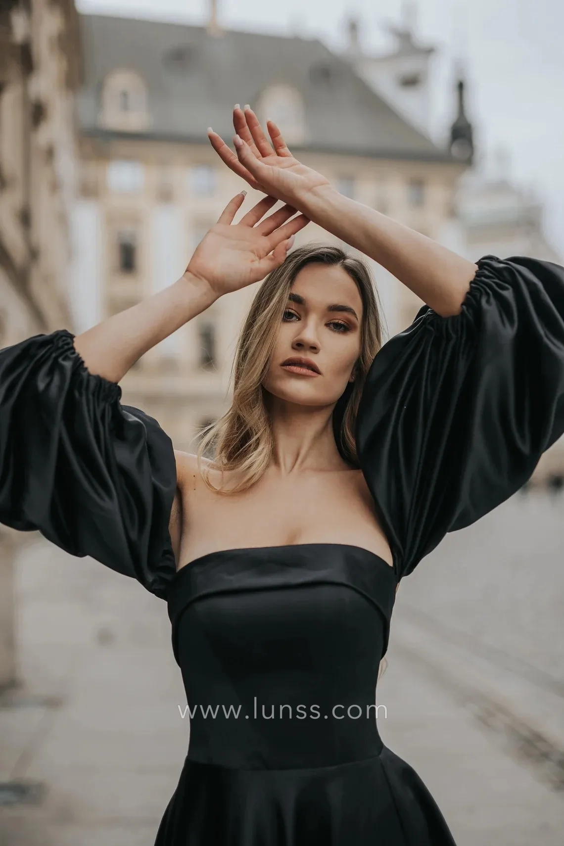black satin strapless evening gown with lantern sleeves