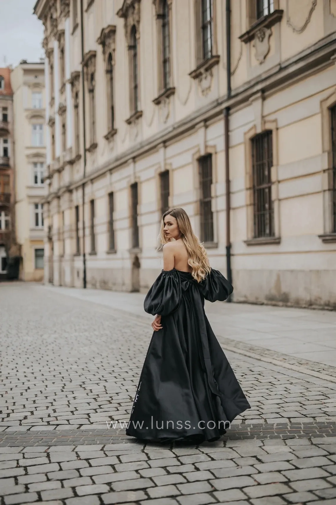 black satin strapless formal dress with puffy sleeves