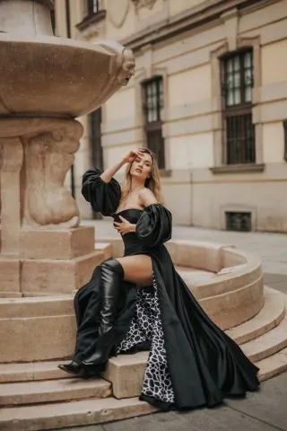 modern black satin evening gown with lantern sleeves