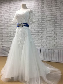 White lace beaded fit and flare tulle wedding dress with royal blue sash