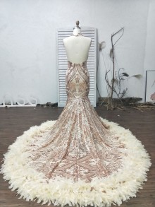 Champagne gold sparkly patterned sequin mermaid prom dress with long feather train and sexy open back