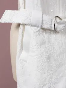 white romper with a sequinned belt