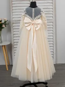 champagne flower girl dress with a bow