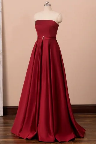 dark red satin strapless slit prom gown with pockets
