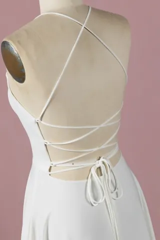 spaghetti straps grace the shoulders and extend to the criss cross back