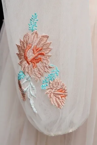 sheer pink sleeve with embroidered flowers