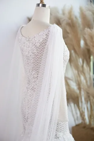 caped sheer long sleeve bridal dress