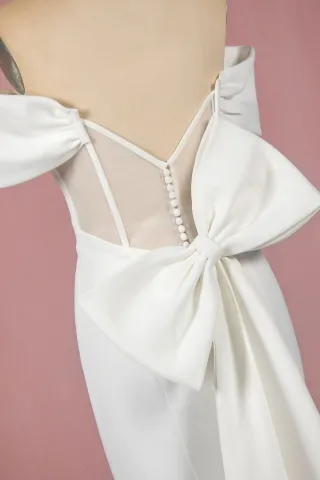 ivory satin mermaid wedding gown with a big bow