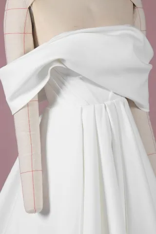 asymmetrical off the shoulder draped bodice