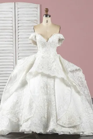 beaded ivory lace luxurious ruffled heavy wedding gown